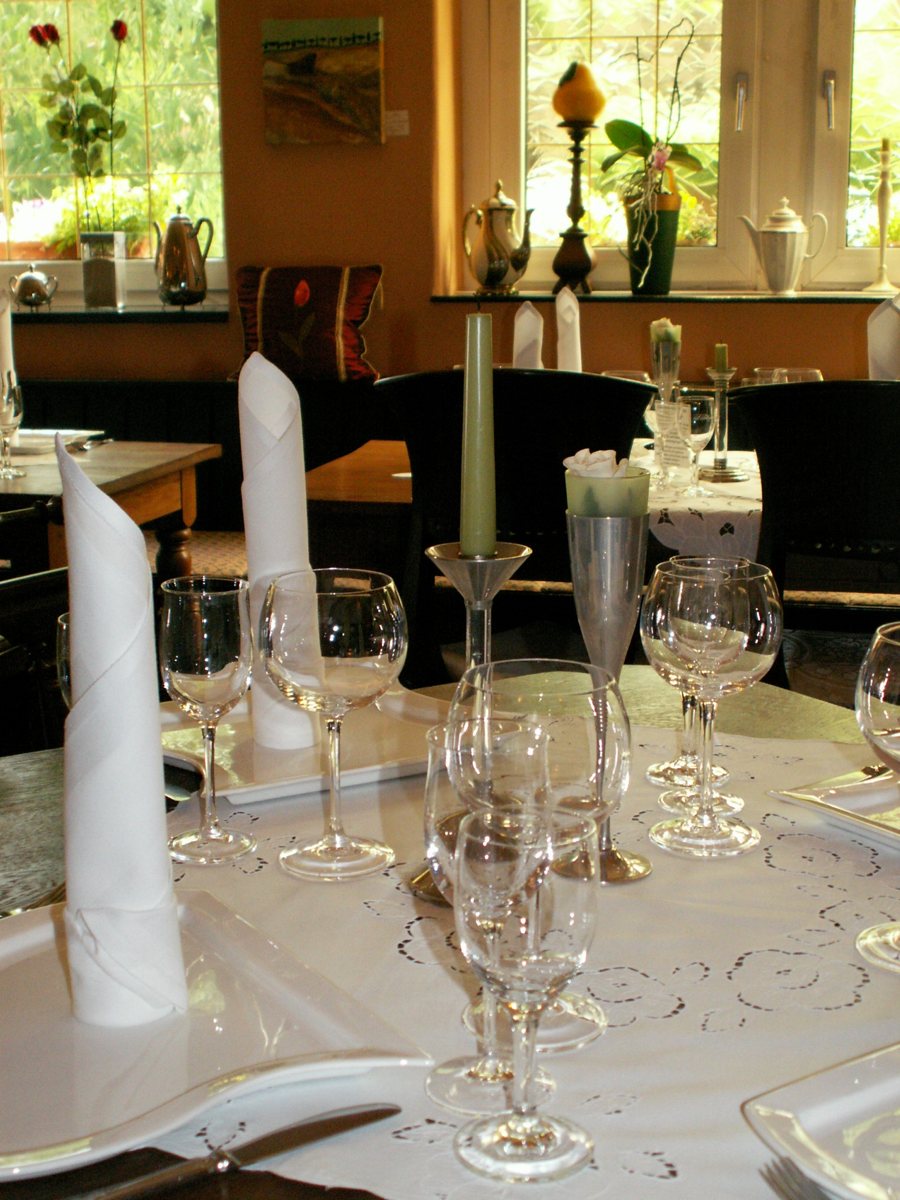 Tavolo apparecchiato con calici e tovaglioli bianchi in un ristorante