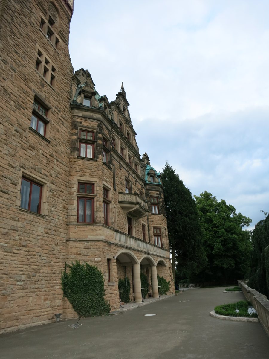 Facciata in pietra di un hotel in un castello con ingresso ad archi